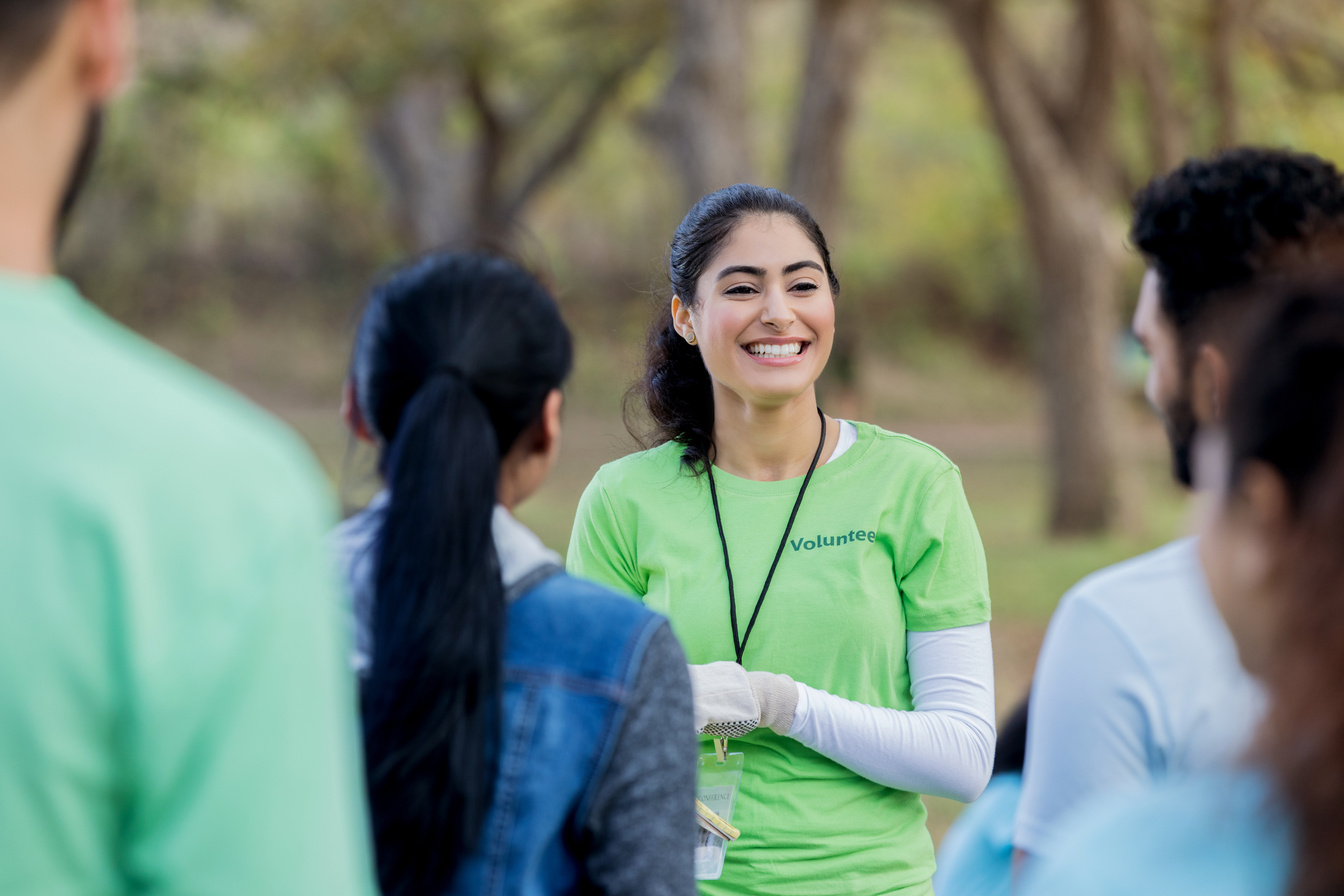 Confident volunteer coordinator instructs volunteers